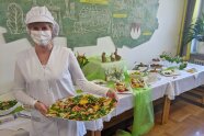 Frau mit Mund-Nasen-Bedeckung hält Schale mit Essen